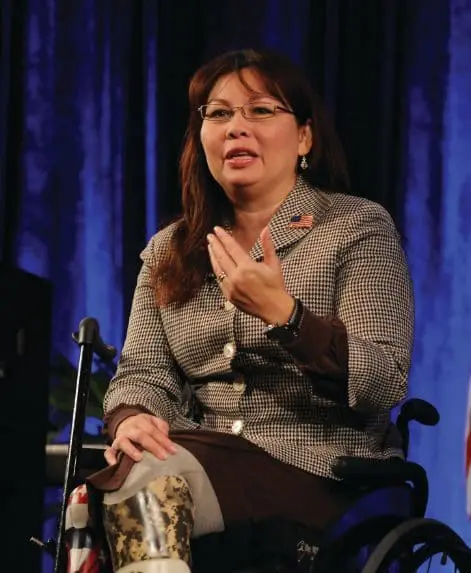 Tammy Duckworth speaking in a wheelchair.
