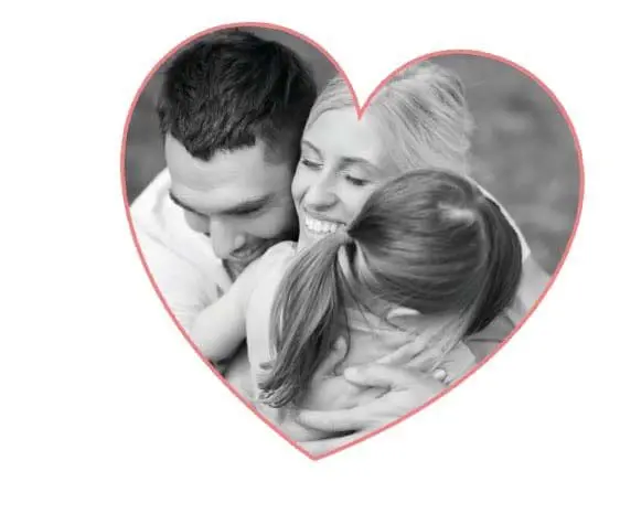 A couple hugs their daughter inside a heart shape