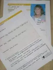 ID of a woman is clipped to a document.