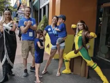 Rachel Hurtado with family and costumed characters.