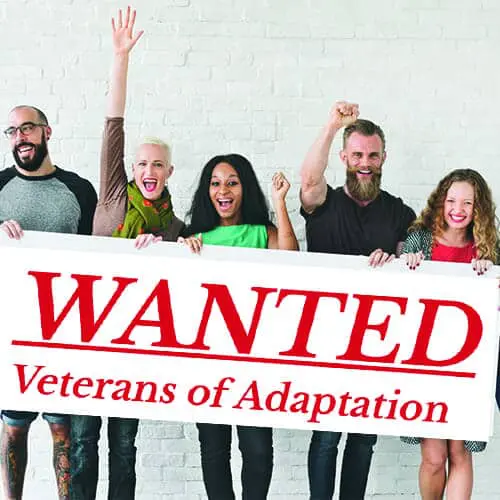 Five people celebrating behind a "WANTED Veterans of Adaptation" sign