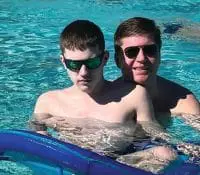 Robin Suzelis and her son Dean in a swimming pool.