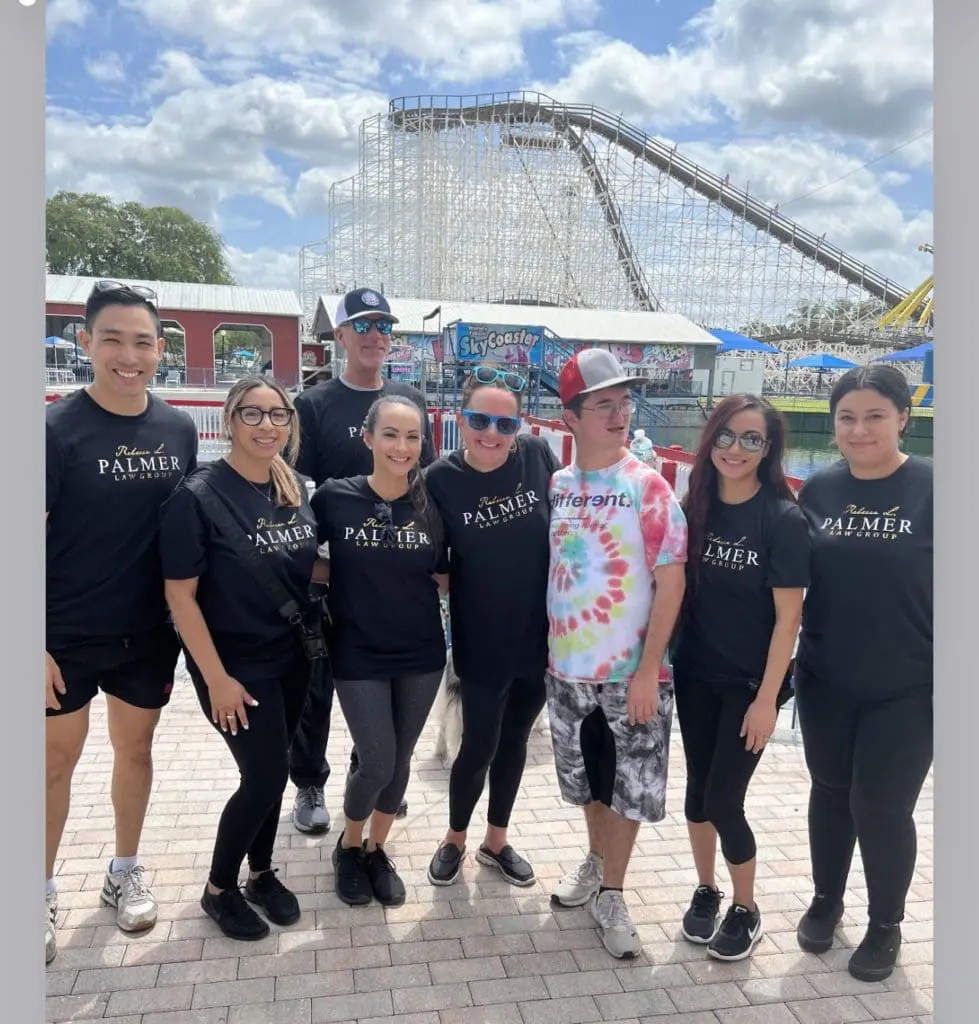 Group of people wearing Palmer t-shirts at an amusement park.