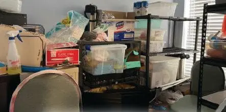 Cluttered shelves and containers in a room before a makeover.