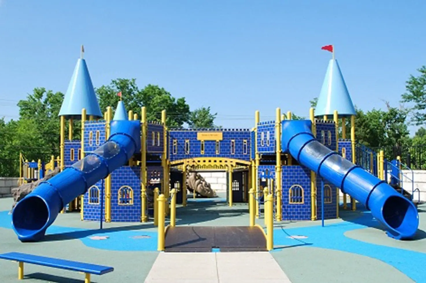 Zachary's Playground, an accessible castle-themed playground, features blue slides and towers.