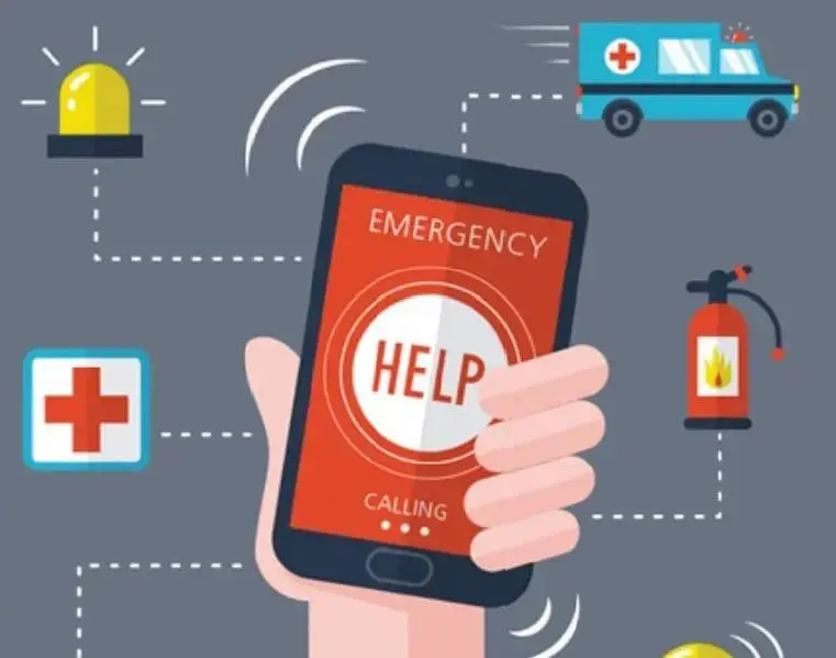 Hand holding a smartphone displaying "EMERGENCY HELP CALLING" with an ambulance, first aid symbol, and fire extinguisher.