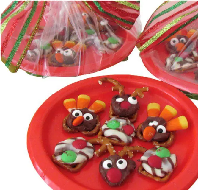 Festive pretzel treats decorated as turkeys and reindeer on a red plate.