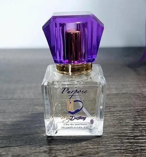 Purpose by My Destiny fragrance bottle with a purple gem-like cap.