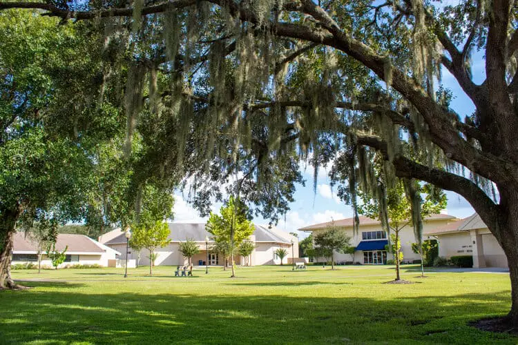 The Vanguard School campus with large oak trees in the foreground.