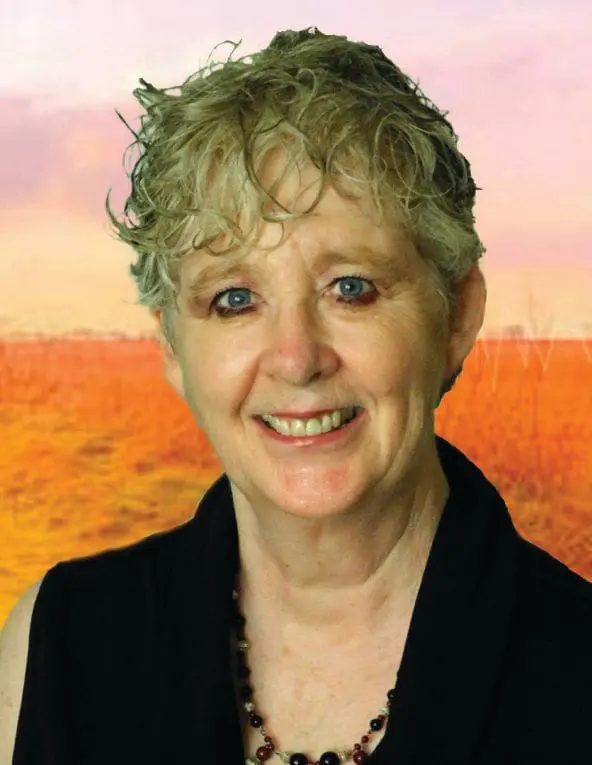 Patricia E. Bailey smiling with a beaded necklace.