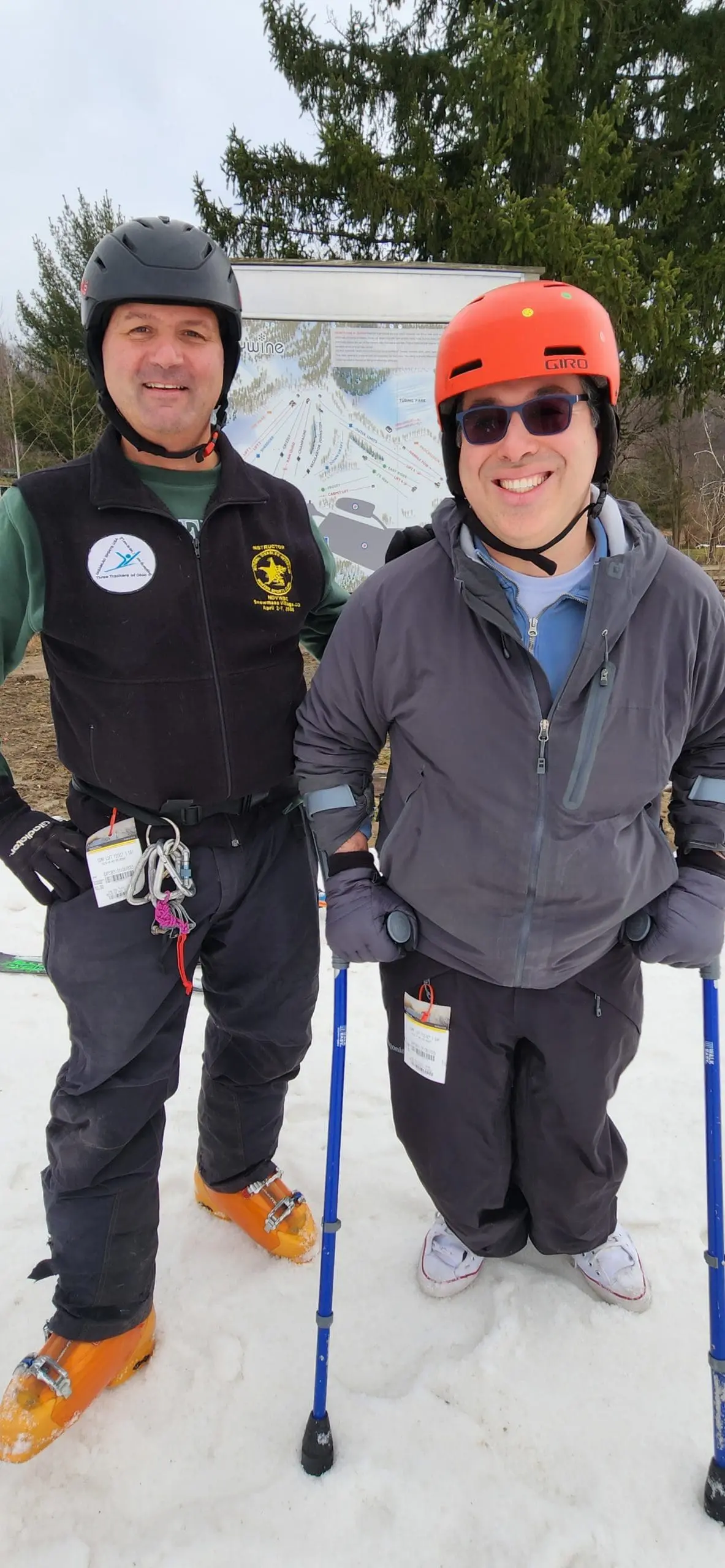 Dr. Christopher Najarian and another person in ski gear stand in the snow.