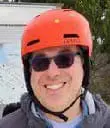 Dr. Christopher Najarian wearing an orange helmet and sunglasses.