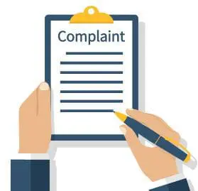 Clipboard labeled Complaint held by one hand while the other writes with a pen.