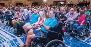Attendees sitting in a large conference hall at the Annual Family Cafe.