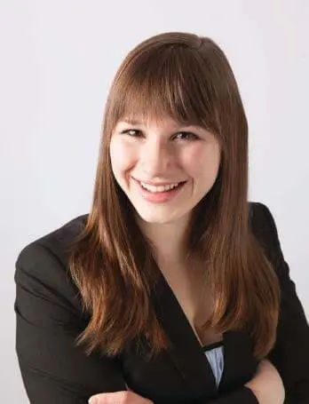 Dr. Deanna Claus smiling with her arms crossed.