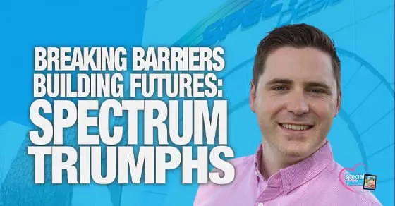 A man smiles in front of a blue background with text "BREAKING BARRIERS BUILDING FUTURES: SPECTRUM TRIUMPHS".