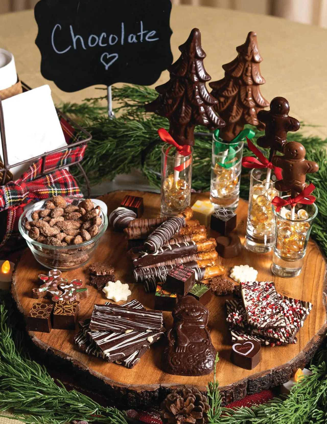 Chocolate charcuterie board with various chocolates and nuts
