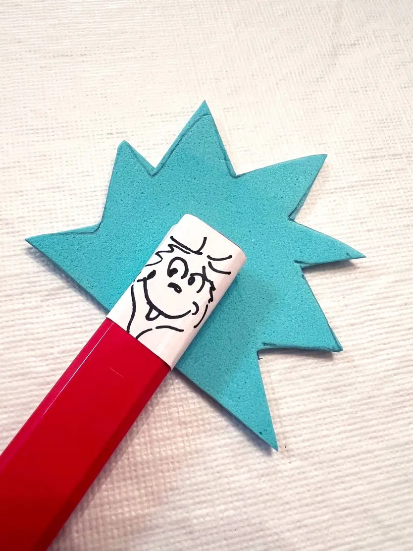 Thing 1 and Thing 2 pencil toppers with blue spiky hair and drawn faces.