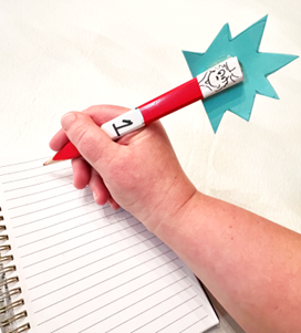 A hand holds a red pencil with a Thing 1 topper and a blue starburst.
