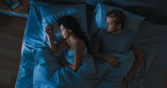 Man and woman sleeping in bed