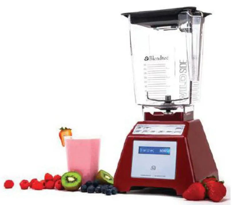 Red Blendtec blender with a pink cup and assorted fruits