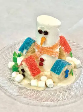 Edible snowman and village made from marshmallows and candy