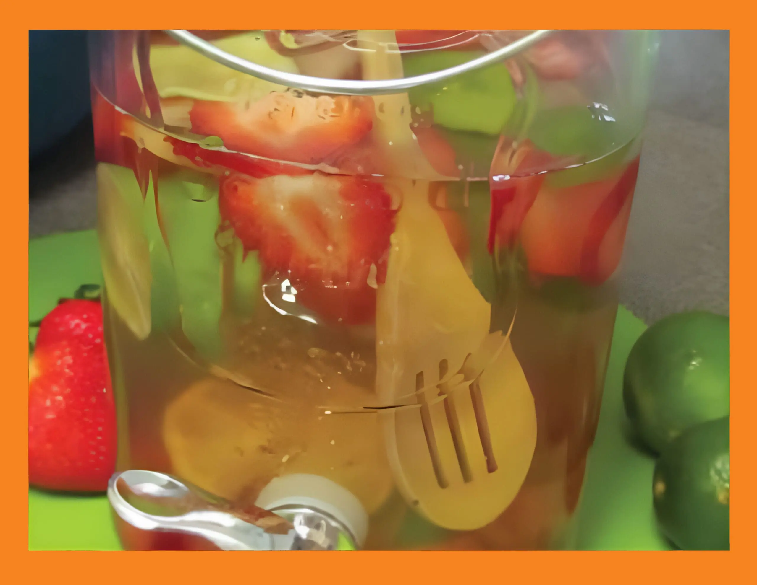 Jar of infused water with strawberries and lime slices