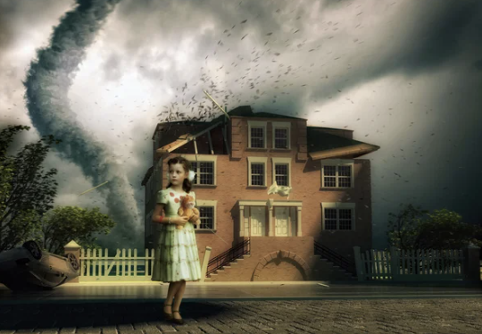A young girl holding an umbrella stands in front of a damaged house with a tornado in the background.