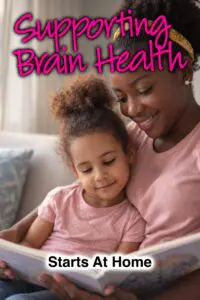 A woman holds a child while reading a book, with the text "Supporting Brain Health Starts At Home" overlayed.