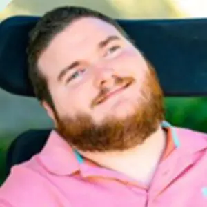 Barrett smiling in a pink polo shirt.