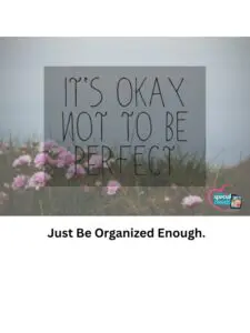 A sign that reads "It's Okay Not To Be Perfect" with pink flowers in the foreground.