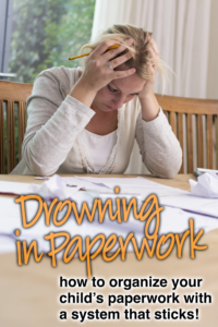Woman resting her head on a table covered in paperwork, looking overwhelmed.
