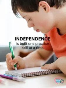 Boy with Downs syndrome writing in a notebook.