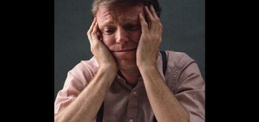 Man with hands on head looking distressed.