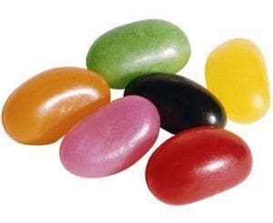 A pile of colorful jelly beans, including red, pink, orange, green, black, and yellow.