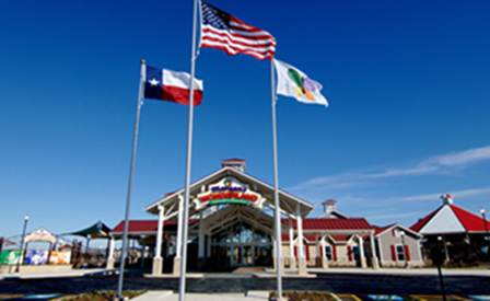 Three flags fly in front of the entrance to Morgan's Wonderland Park.