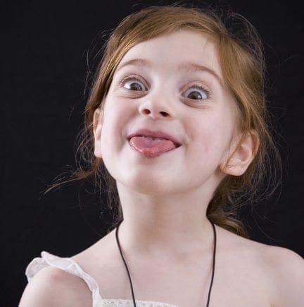 Girl sticking tongue out with a playful expression