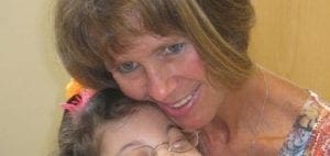 Patricia Biagioli embracing a child.