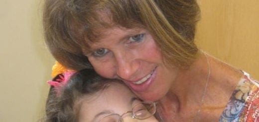 Patricia Biagioli embracing a child.