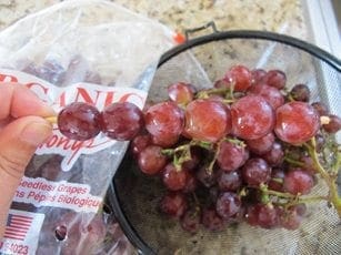 Grapes are placed on a skewer to create a frozen caterpillar.