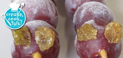 Frozen grapes on skewers decorated with raisins to look like caterpillars.