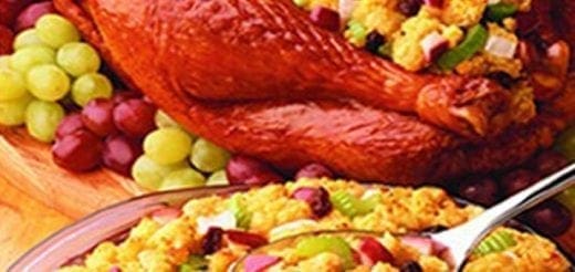 Roasted turkey leg with stuffing and grapes.