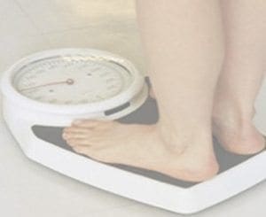 Feet on a white analog scale.