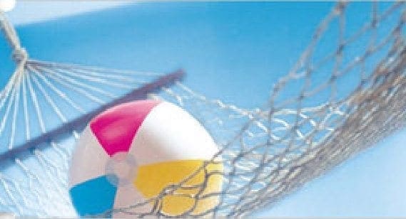Beach ball in a hammock against a blue sky.