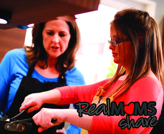 Valerie Strohl and her daughter Sarah cook together in a kitchen.
