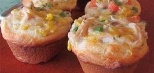 Chicken pot pie cupcakes with mixed vegetables on a red plate.