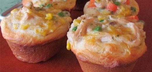 Chicken pot pie cupcakes with mixed vegetables on a red plate.