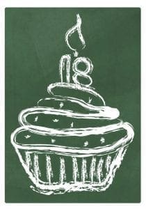 Cupcake with the number 18 and a lit candle on top.