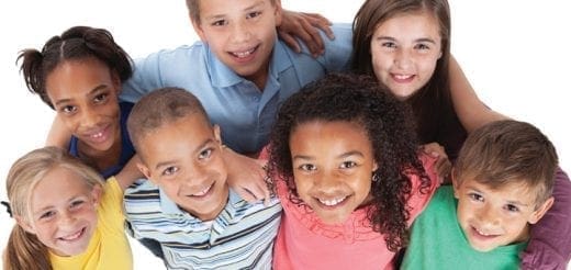 Group of diverse children smiling together.