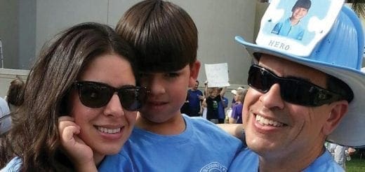 Pete Villasuso and his family wearing blue shirts.